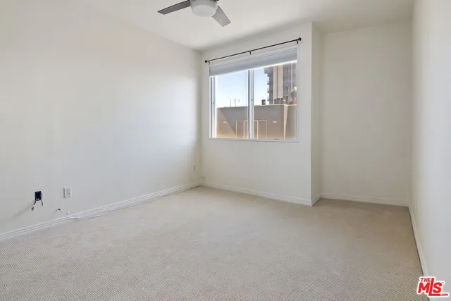 a view of an empty room with a cabinet