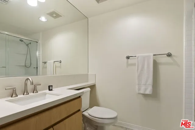 a bathroom with a shower and a toilet