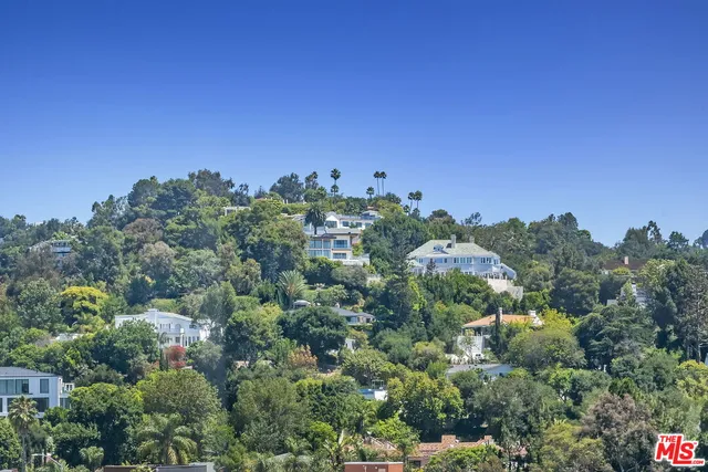 a living room with a bed and a window