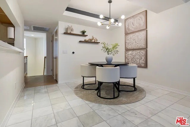 a kitchen with a table and chairs