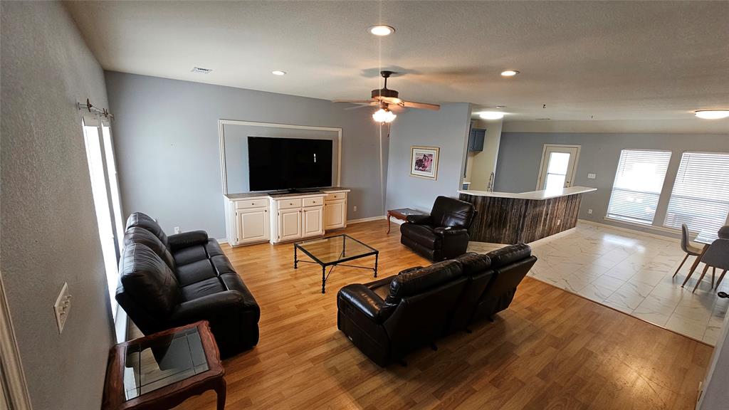 611 Gladness Rhome, TX 76078 - Photo 12 of 40 a living room with furniture and a flat screen tv