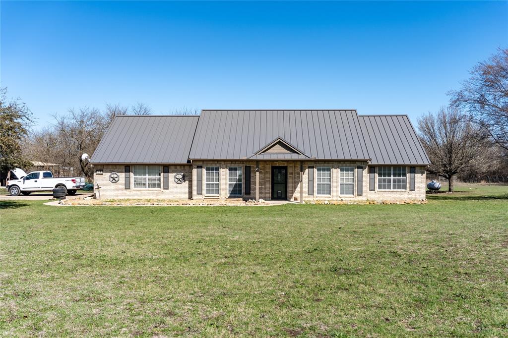 611 Gladness Rhome, TX 76078 - Photo 2 of 40 a front view of a house with a garden