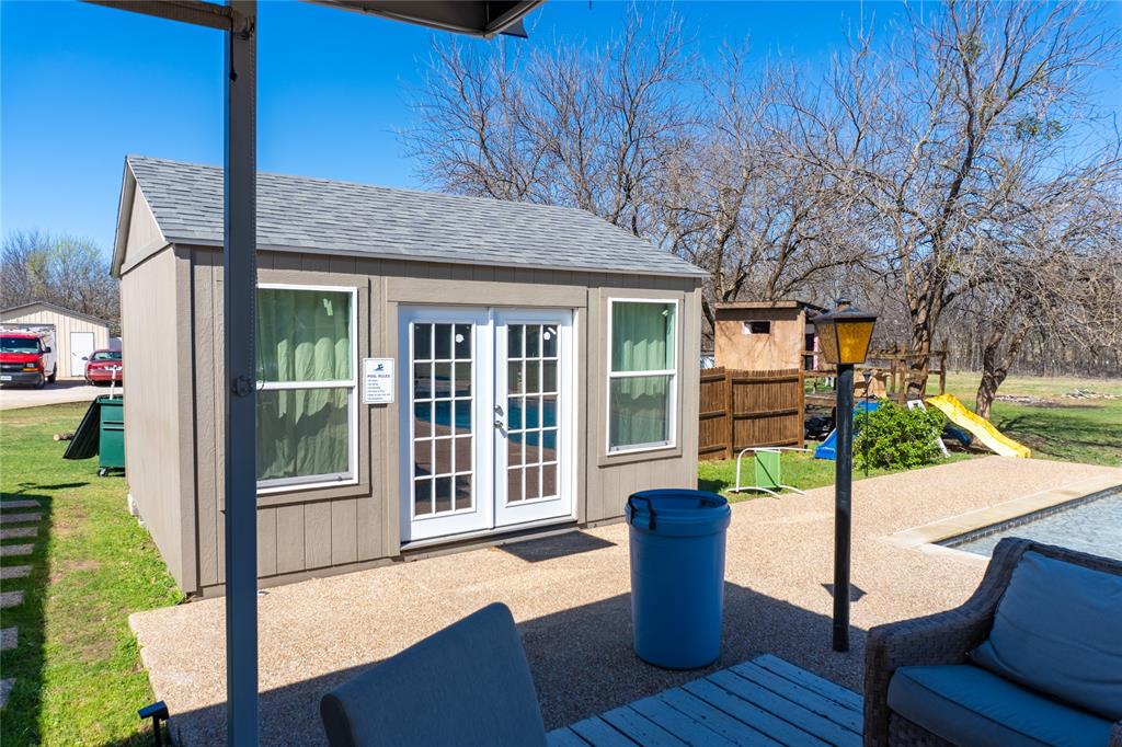 611 Gladness Rhome, TX 76078 - Photo 27 of 40 a view of a house with backyard and porch