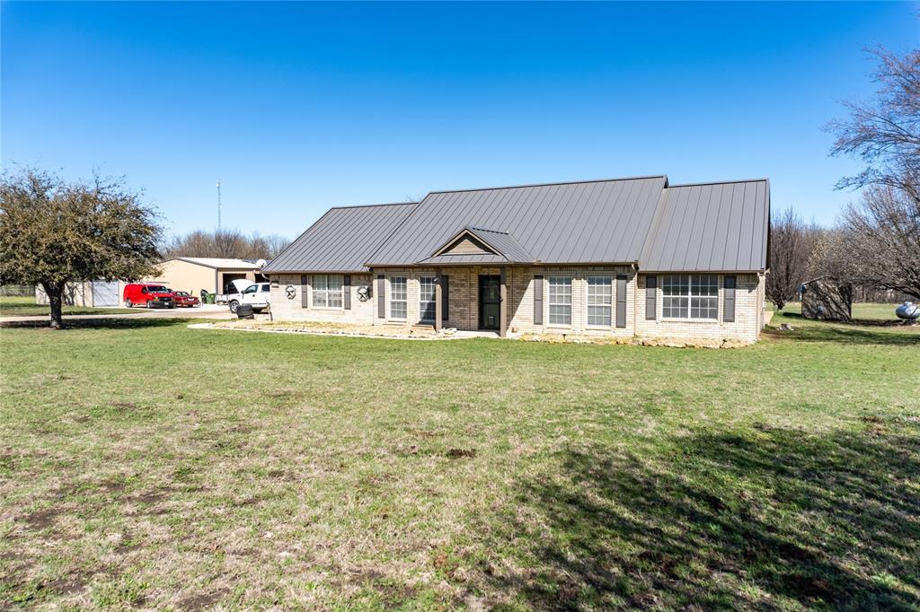 611 Gladness Rhome, TX 76078 - Photo 3 of 40 a house view with a garden space