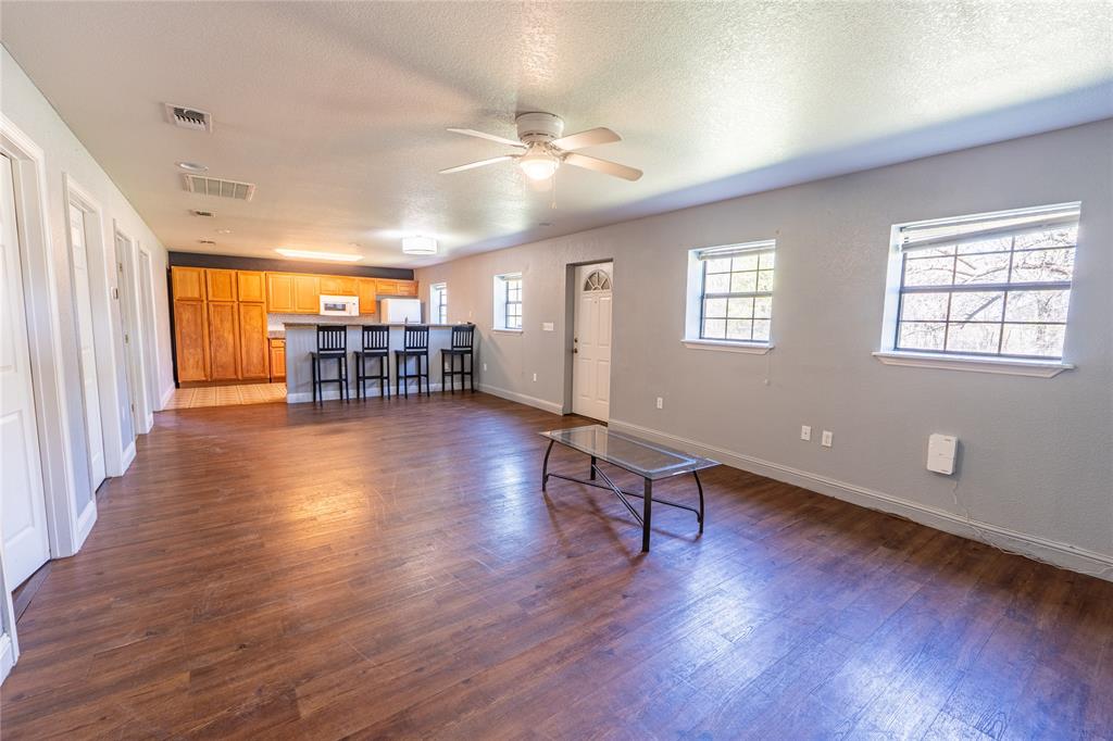 611 Gladness Rhome, TX 76078 - Photo 38 of 40 an empty room with wooden floor and windows