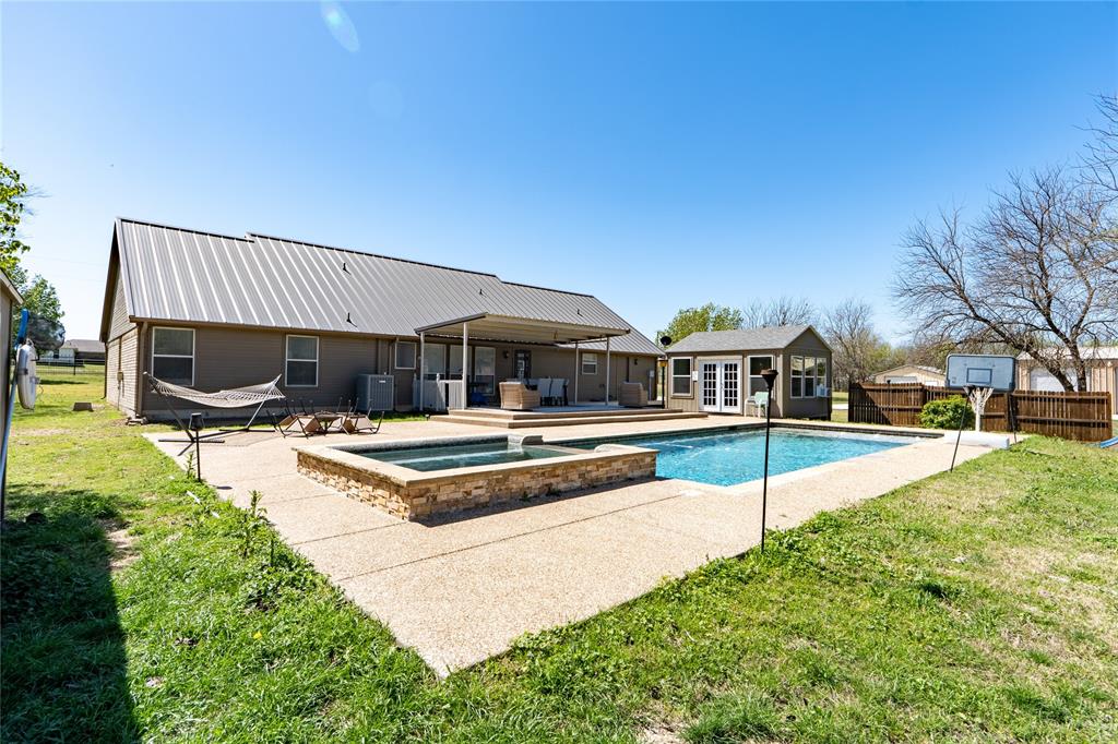 611 Gladness Rhome, TX 76078 - Photo 5 of 40 a view of a house with swimming pool and sitting area