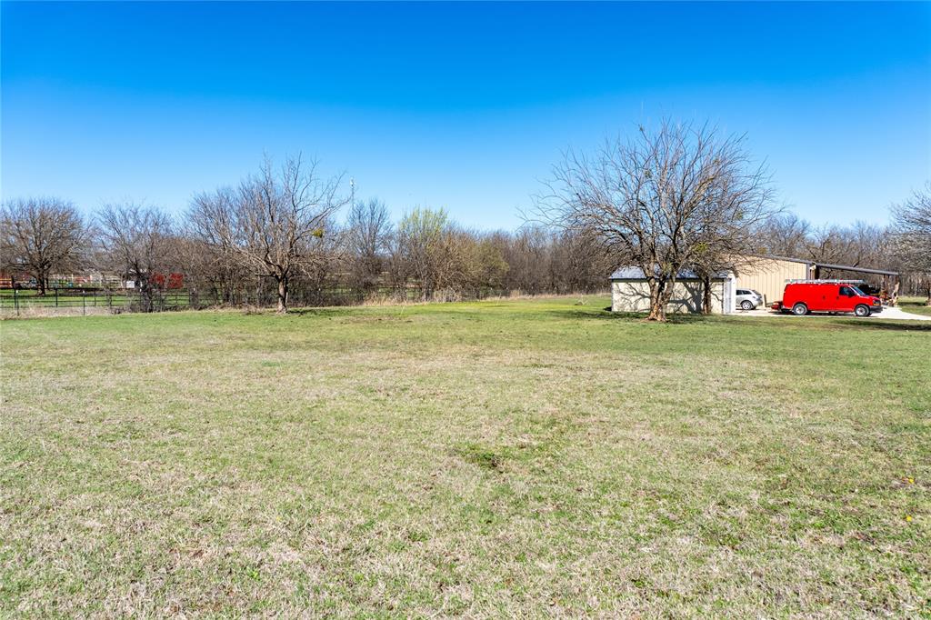 611 Gladness Rhome, TX 76078 - Photo 7 of 40 a view of a field with trees in the background