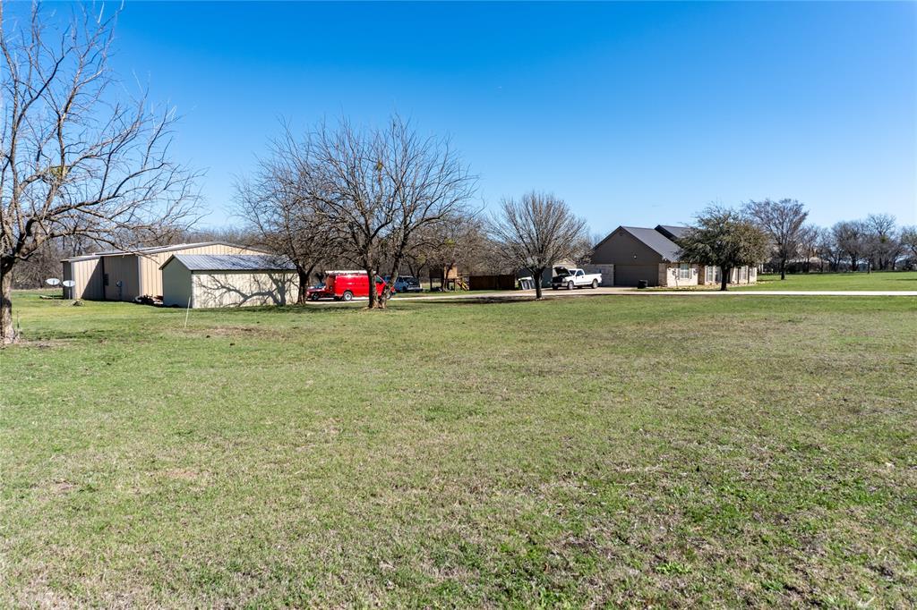 611 Gladness Rhome, TX 76078 - Photo 8 of 40 a view of a field of grass and trees