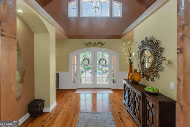 a living room with furniture a dining table and a large window