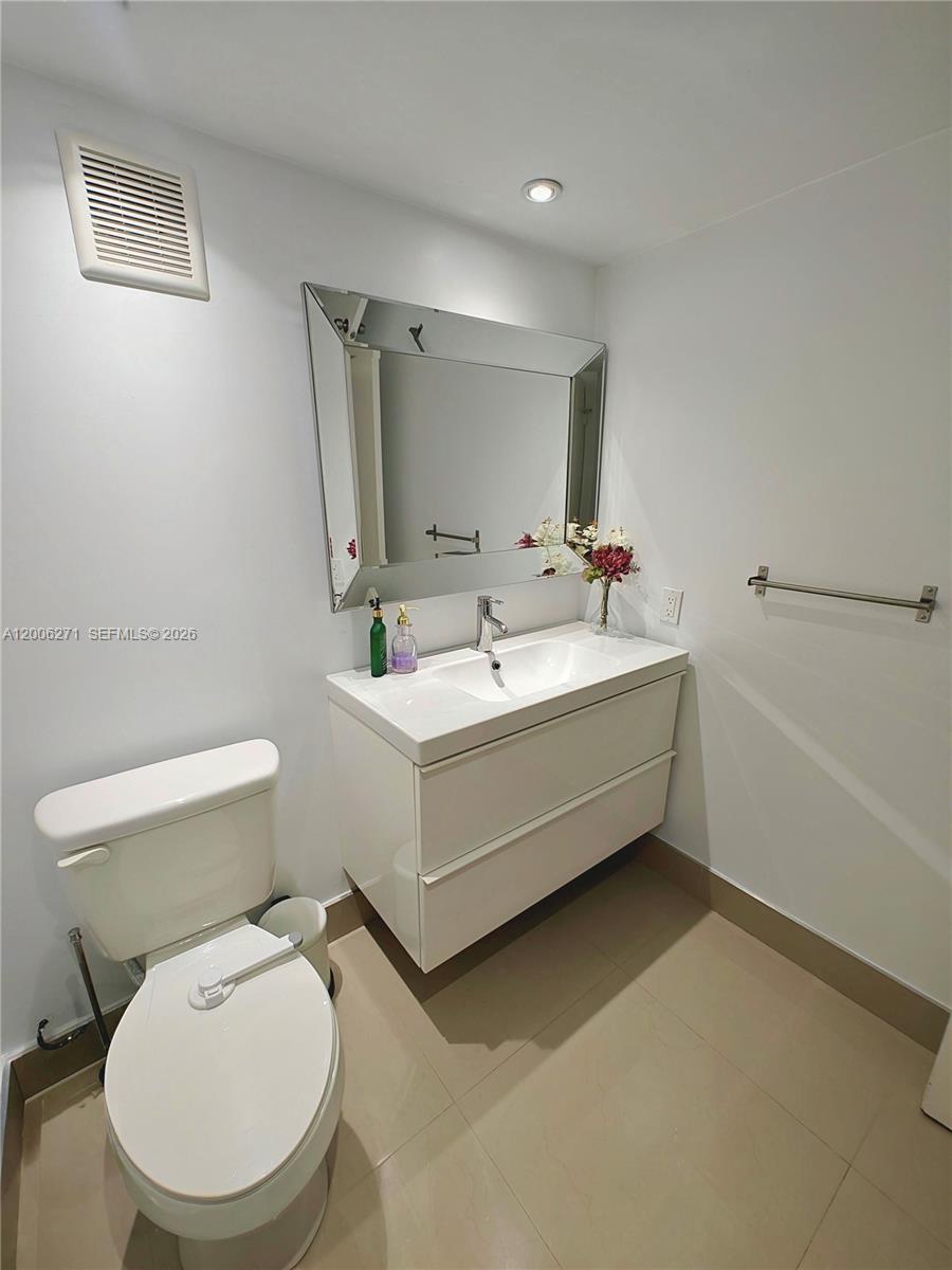 16300 Golf Club Road, Unit 204 Weston, FL 33326 - Photo 11 of 16 a bathroom with a sink mirror vanity and toilet