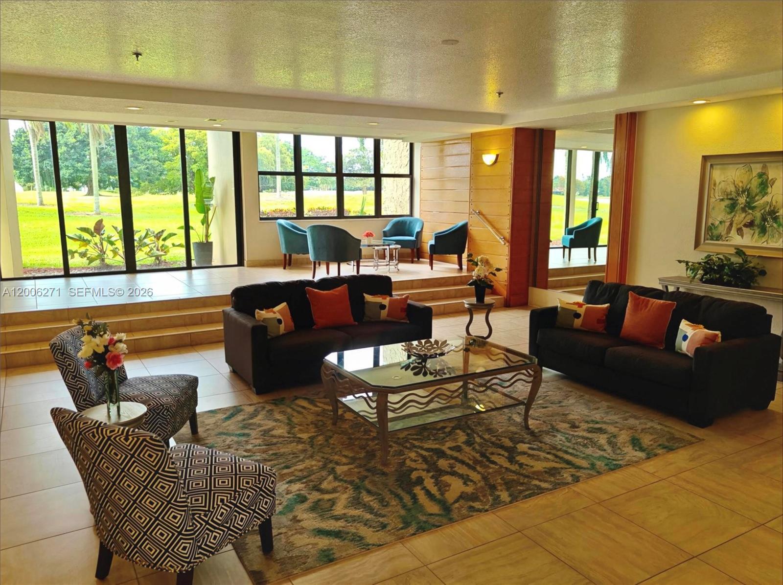 16300 Golf Club Road, Unit 204 Weston, FL 33326 - Photo 14 of 16 a living room with furniture and a large window