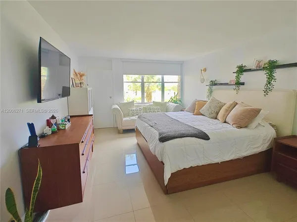 a bedroom with bed and window