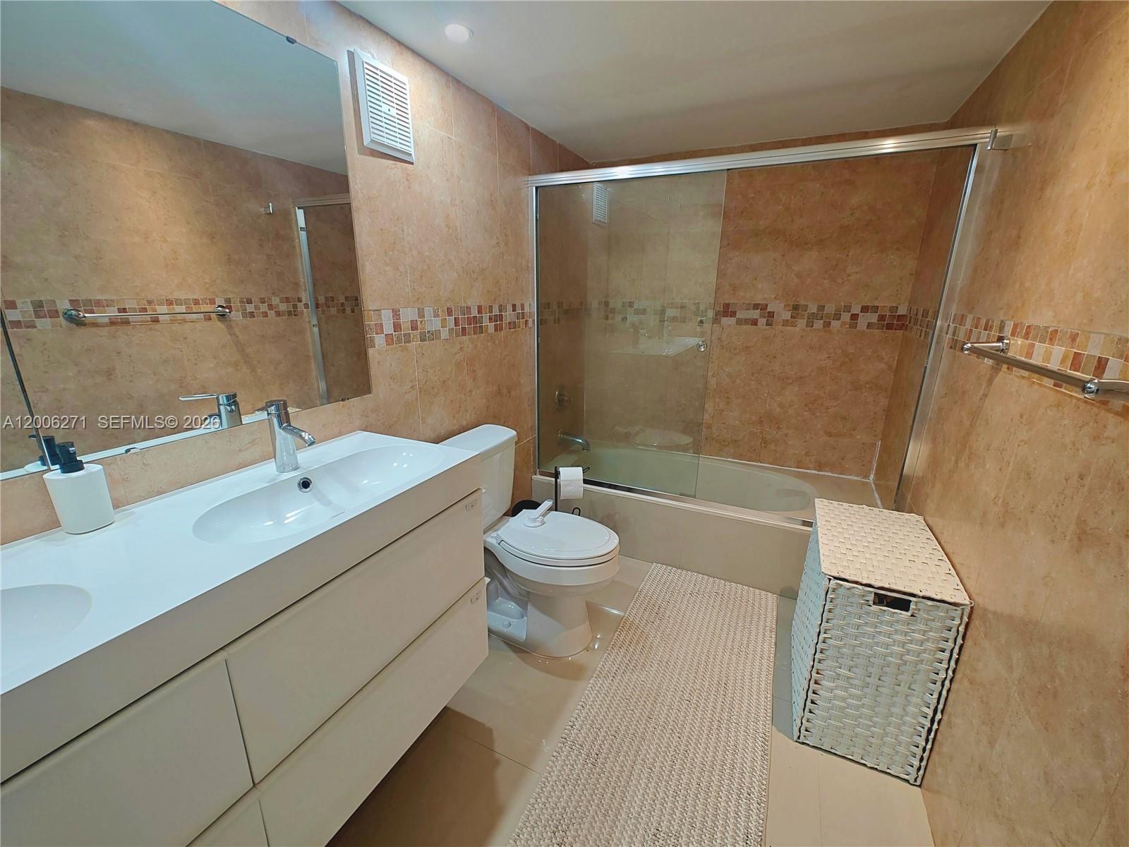 16300 Golf Club Road, Unit 204 Weston, FL 33326 - Photo 4 of 16 a bathroom with a sink a toilet and shower