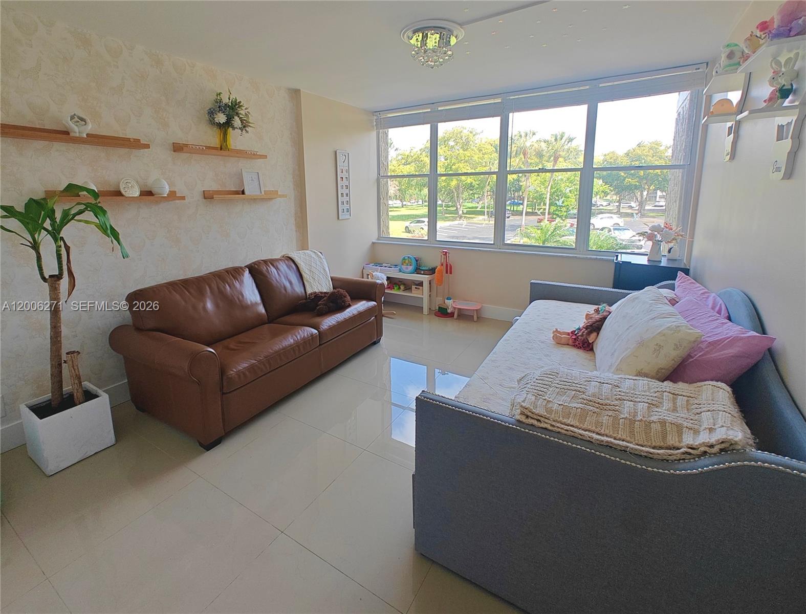 16300 Golf Club Road, Unit 204 Weston, FL 33326 - Photo 7 of 16 a living room with furniture and a large window