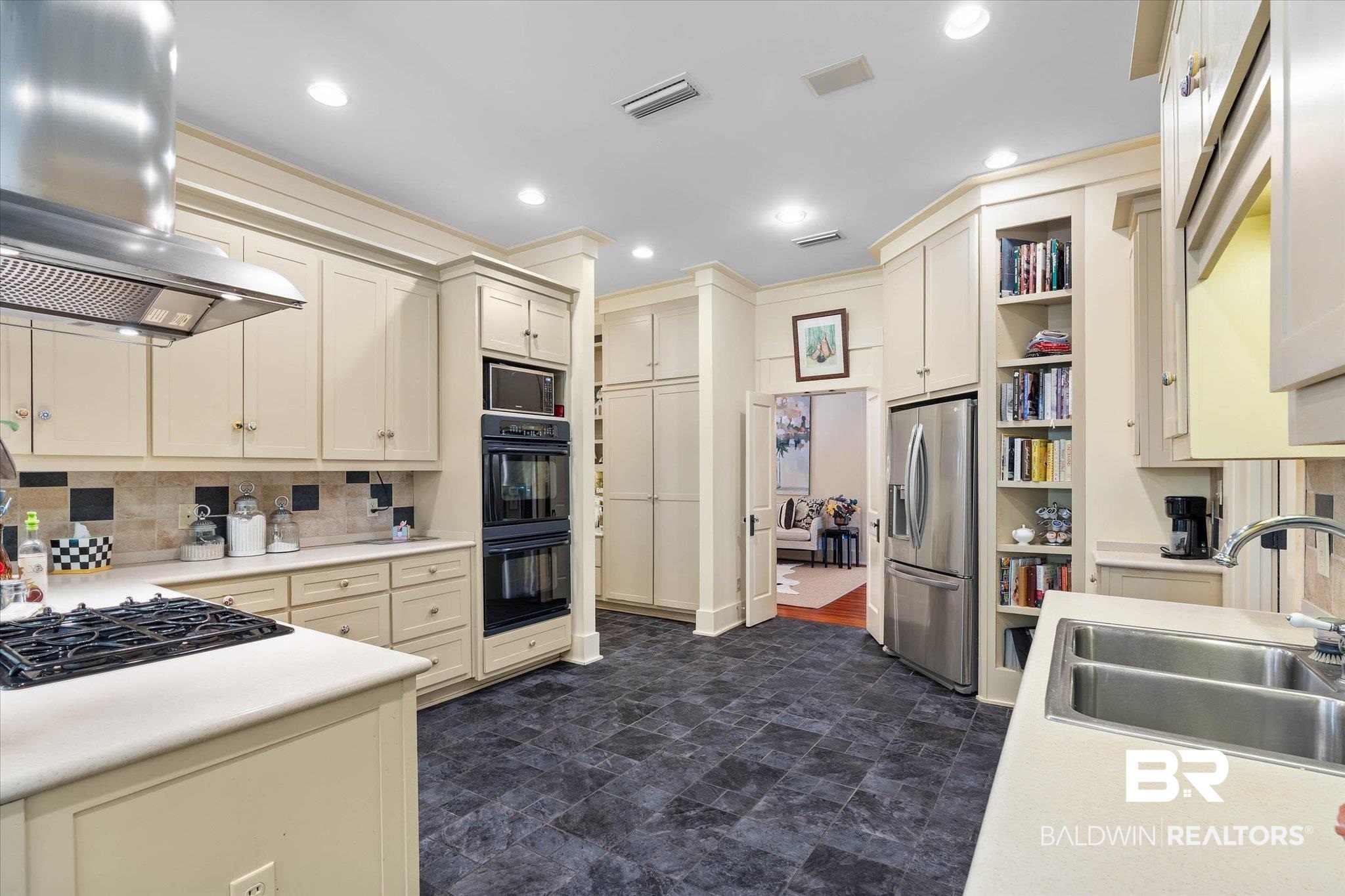 2300 Burgett Road Mobile, AL 36605 - Photo 10 of 40 Kitchen featuring cream cabinets, ventilation hood, black appliances, light countertops, and recessed lighting