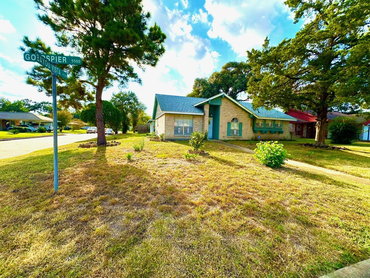 FRONT OF THE HOUSE IN A CORNER LOT.
