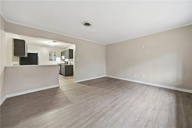 a view of a kitchen with a sink and a refrigerator