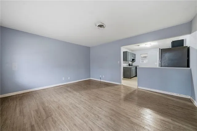 a view of a kitchen with a sink and a refrigerator