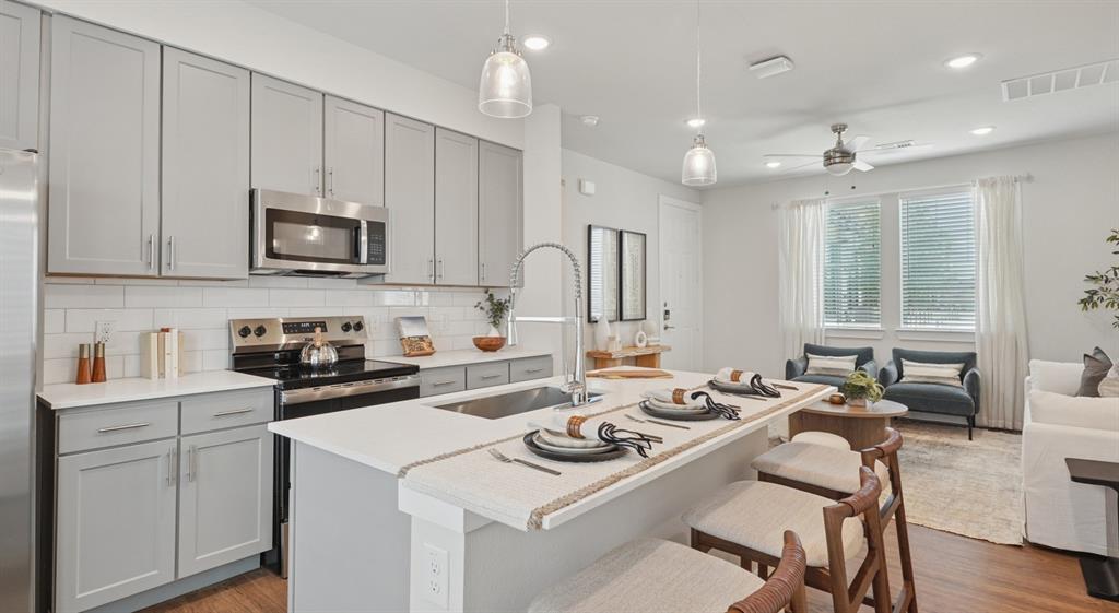 9013 Peridot Way Fort Worth, TX 76123 - Photo 10 of 27 a kitchen that has a lot of cabinets a sink and a stove in it