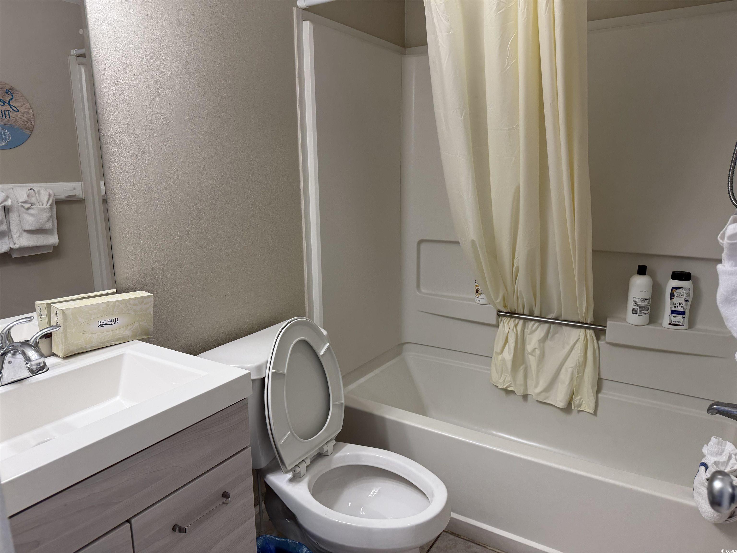 1605 South Ocean Boulevard, Unit 1211 Myrtle Beach, SC 29577 - Photo 14 of 22 Living area featuring dark wood-style floors and baseboards