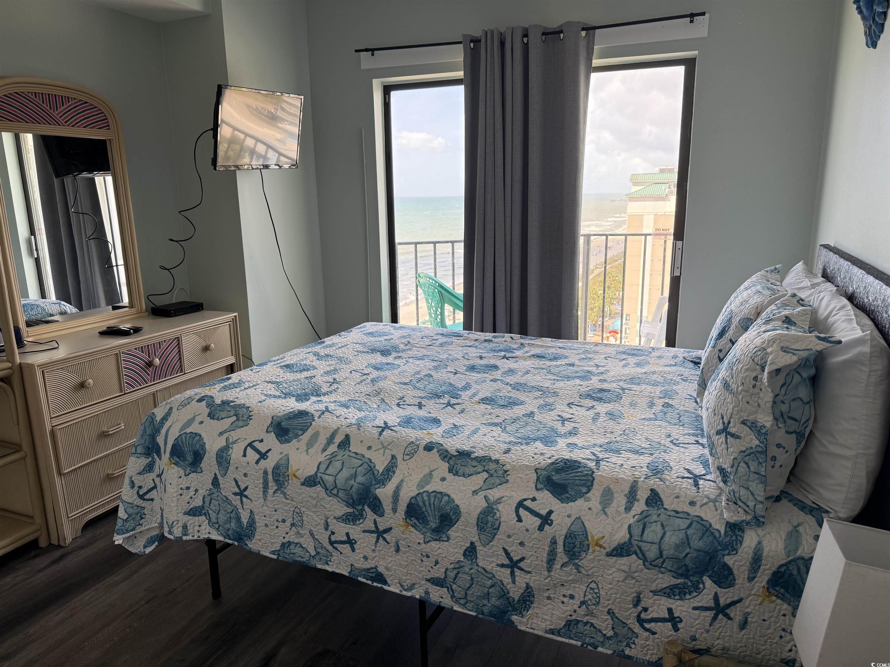 1605 South Ocean Boulevard, Unit 1211 Myrtle Beach, SC 29577 - Photo 16 of 22 Bathroom featuring shower / bathtub combination with curtain, vanity, and tile patterned flooring