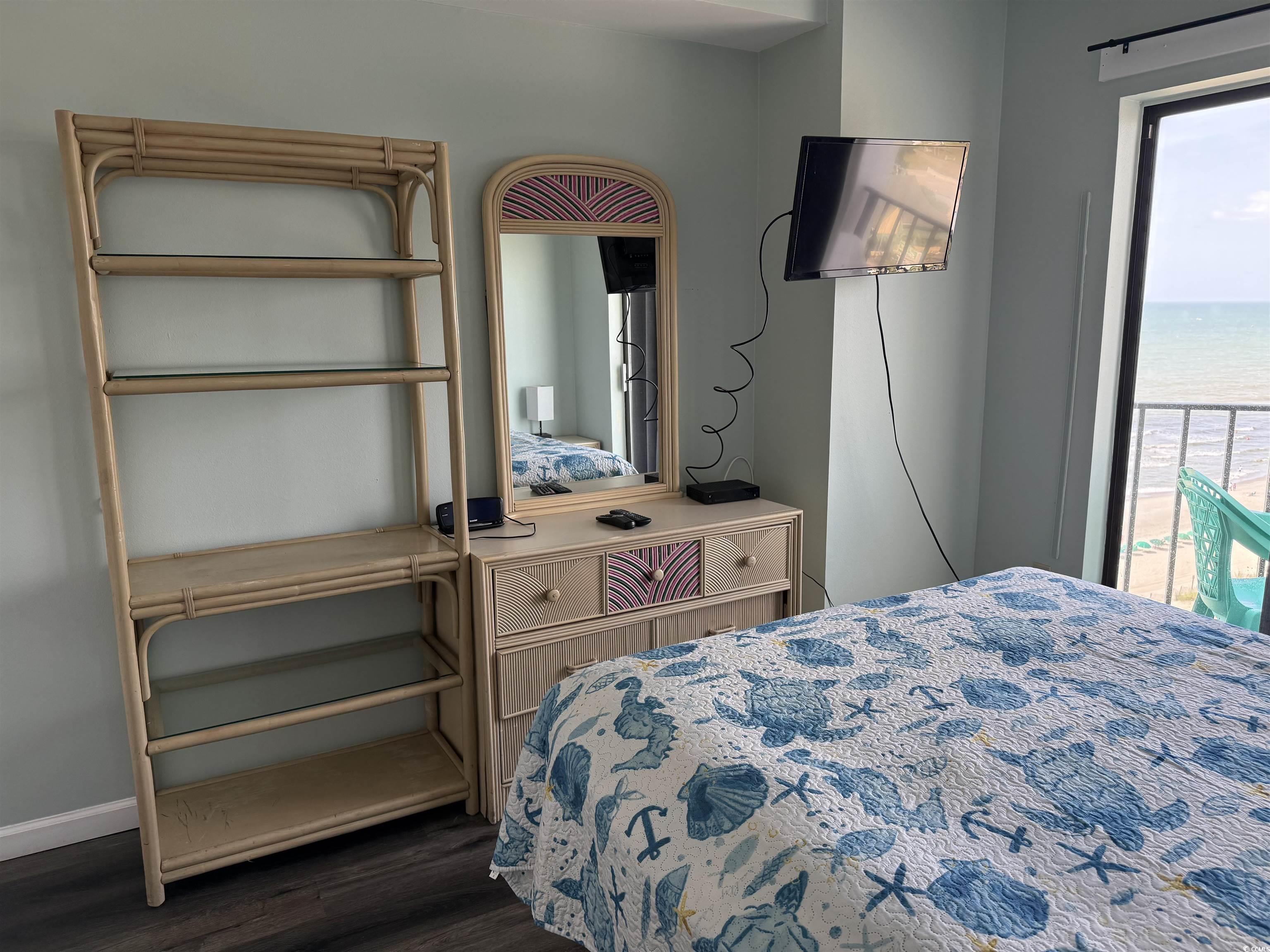 1605 South Ocean Boulevard, Unit 1211 Myrtle Beach, SC 29577 - Photo 17 of 22 Bedroom featuring dark wood finished floors and access to outside