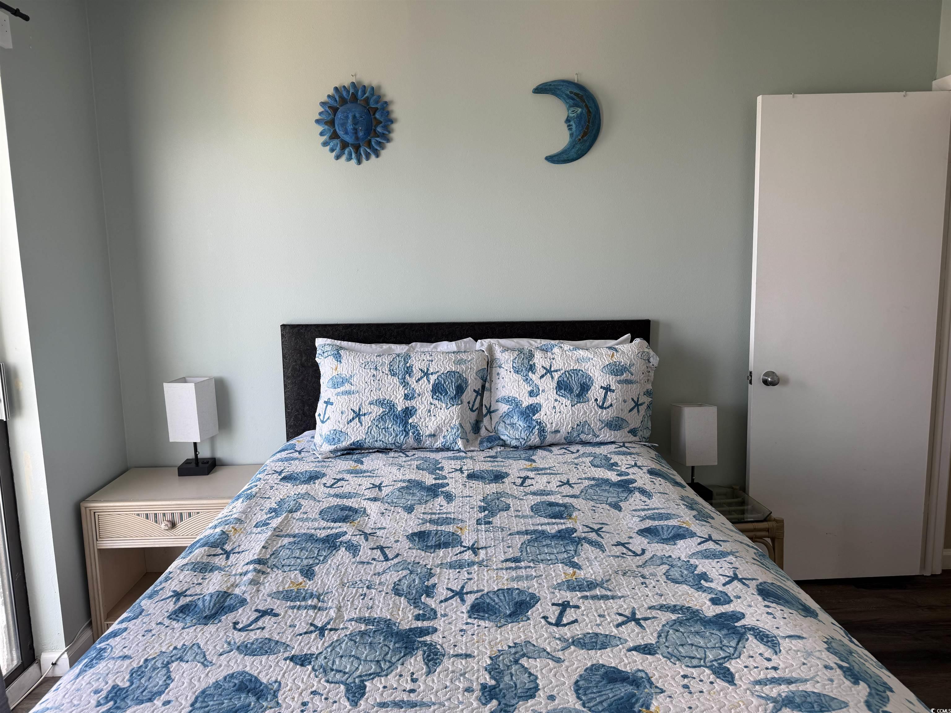 1605 South Ocean Boulevard, Unit 1211 Myrtle Beach, SC 29577 - Photo 18 of 22 Bedroom with dark wood-style floors and baseboards