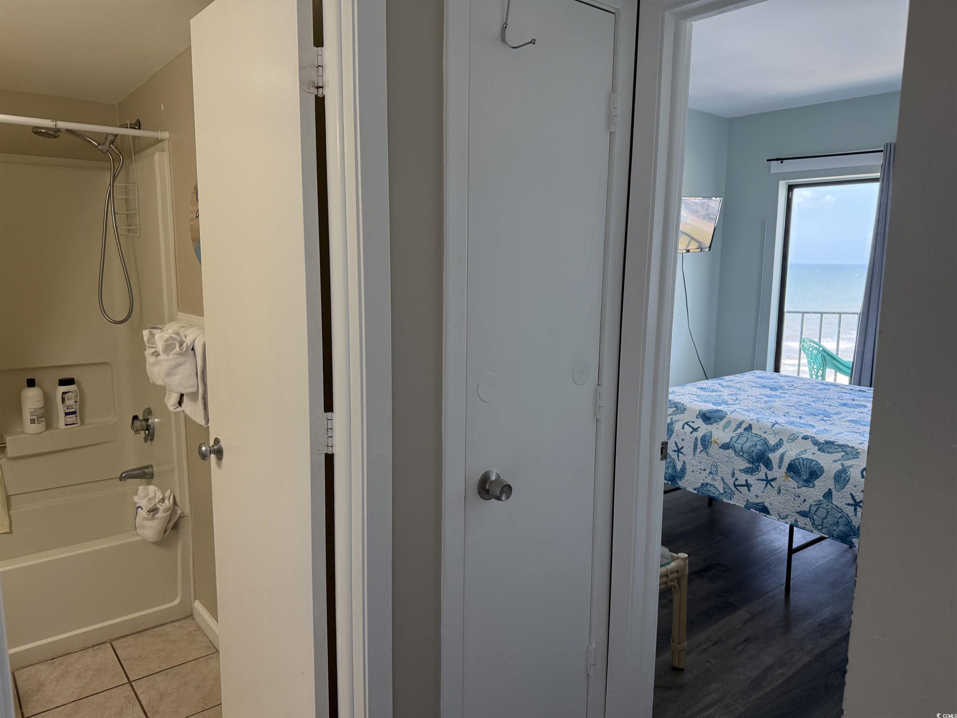 1605 South Ocean Boulevard, Unit 1211 Myrtle Beach, SC 29577 - Photo 20 of 22 Bedroom featuring view of water and beach