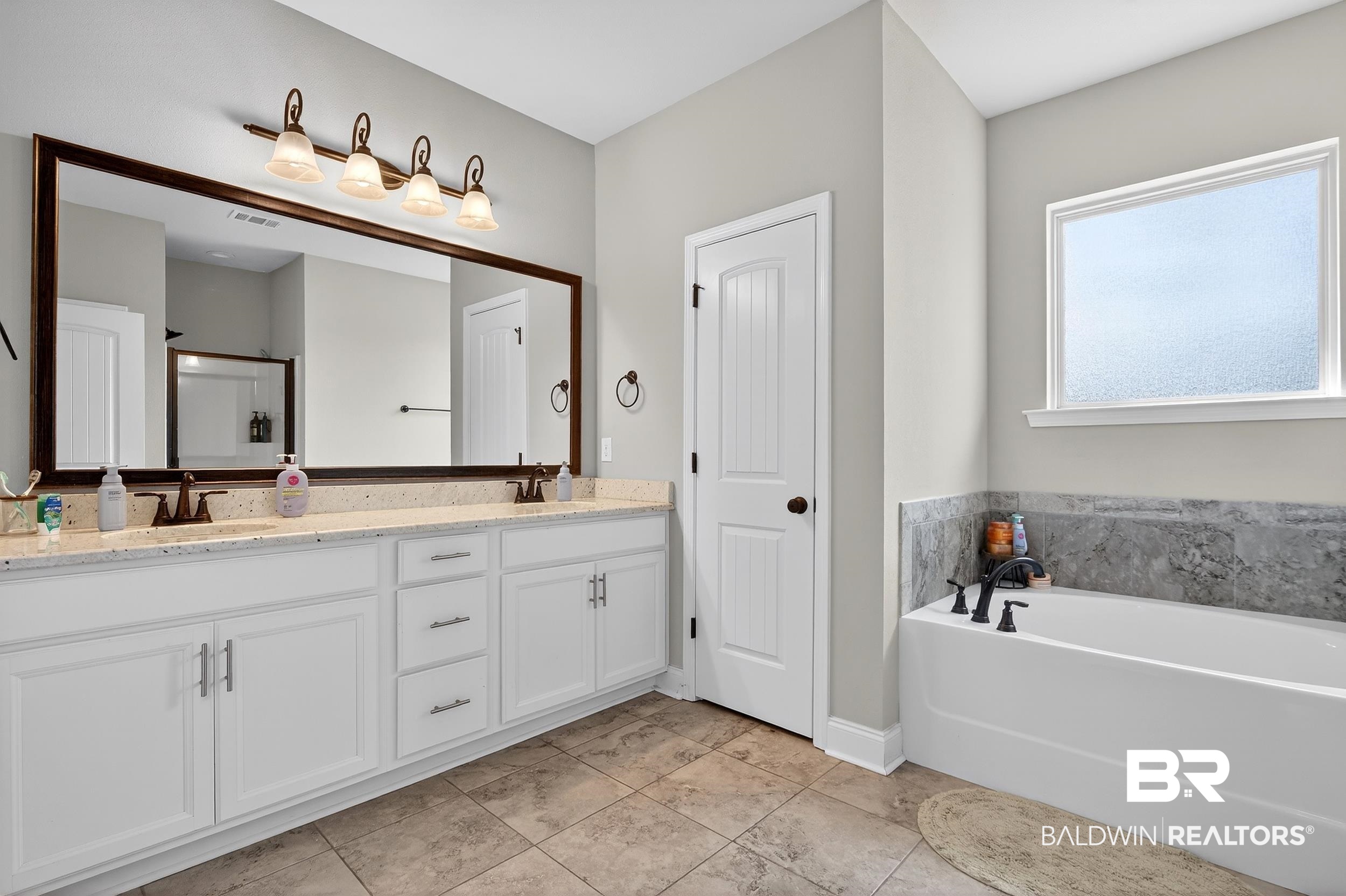 1084 Stella Road Foley, AL 36535 - Photo 19 of 31 Full bathroom with double vanity, a bath, and a shower stall