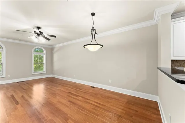 a view of a room with a ceiling fan and a window