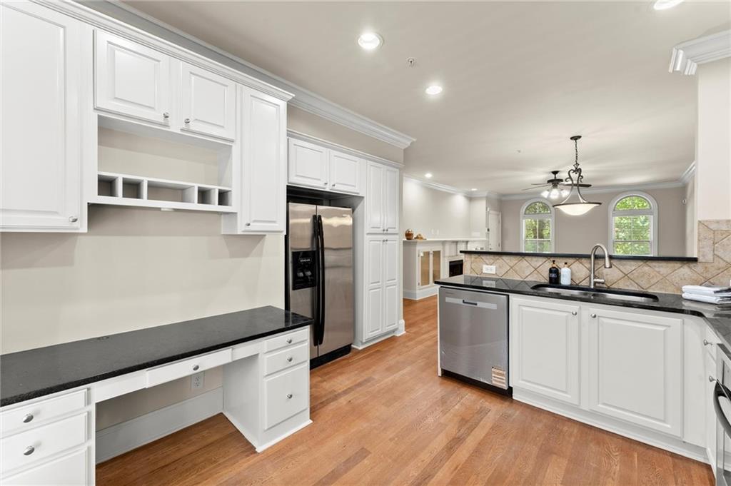 6468 Chariot Street, Unit 19 Atlanta, GA 30328 - Photo 15 of 43 a kitchen with stainless steel appliances granite countertop a sink a stove and a refrigerator