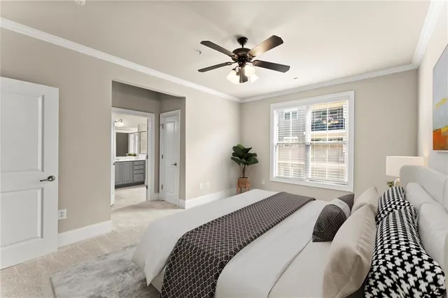 a bedroom with a large bed and a chandelier