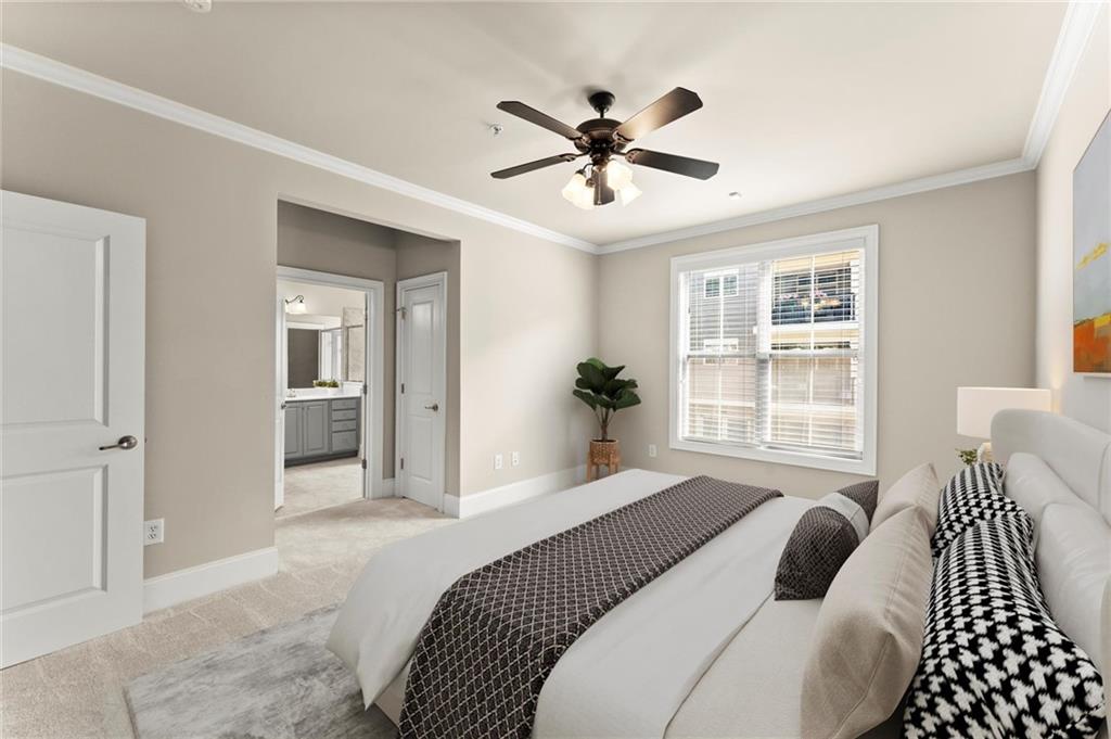 6468 Chariot Street, Unit 19 Atlanta, GA 30328 - Photo 16 of 43 a bedroom with a large bed and a chandelier