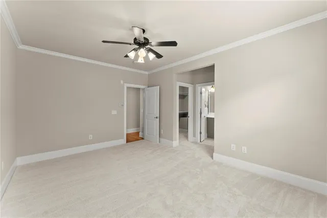 a view of an empty room with a ceiling fan
