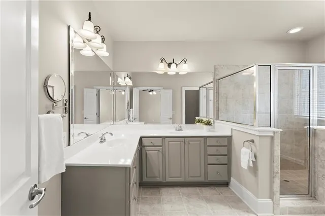 a spacious bathroom with a sink a mirror and a shower