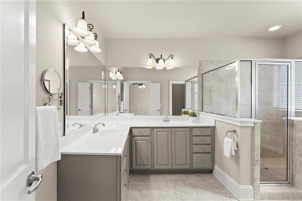 6468 Chariot Street, Unit 19 Atlanta, GA 30328 - Photo 19 of 43 a spacious bathroom with a sink a mirror and a shower