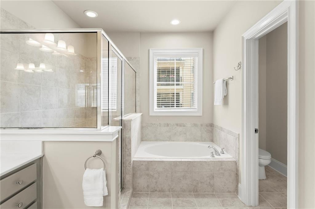 6468 Chariot Street, Unit 19 Atlanta, GA 30328 - Photo 20 of 43 a bathroom with a bathtub and a shower