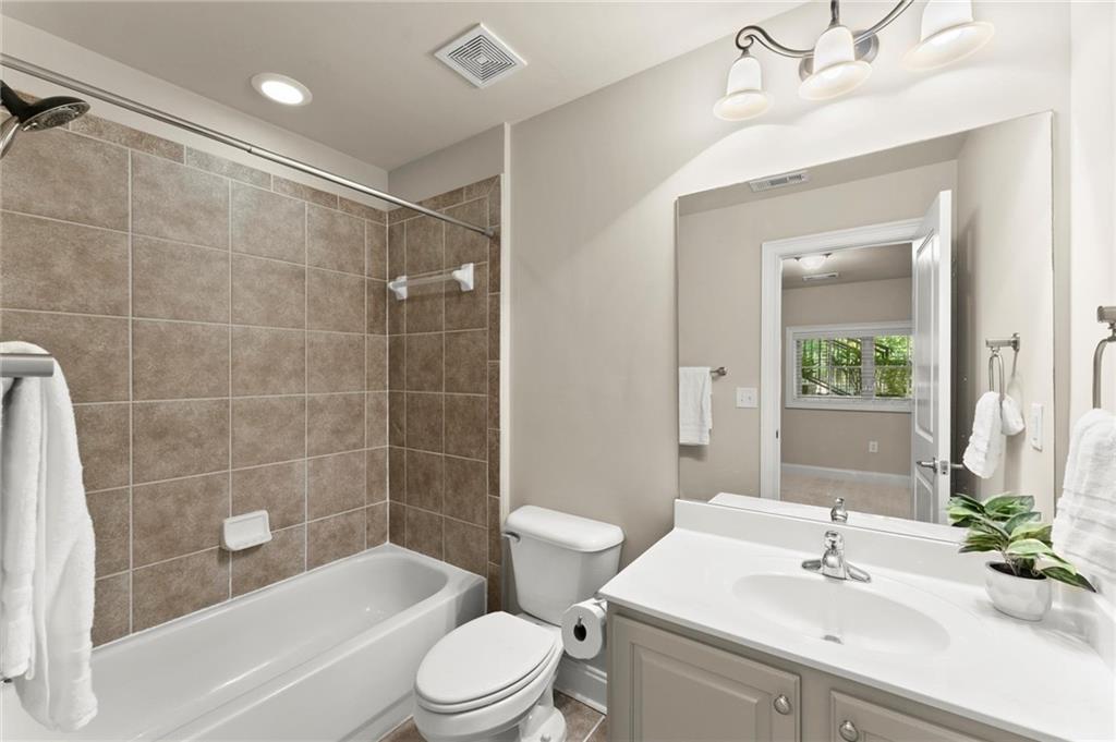 6468 Chariot Street, Unit 19 Atlanta, GA 30328 - Photo 29 of 43 a bathroom with a sink a toilet and shower