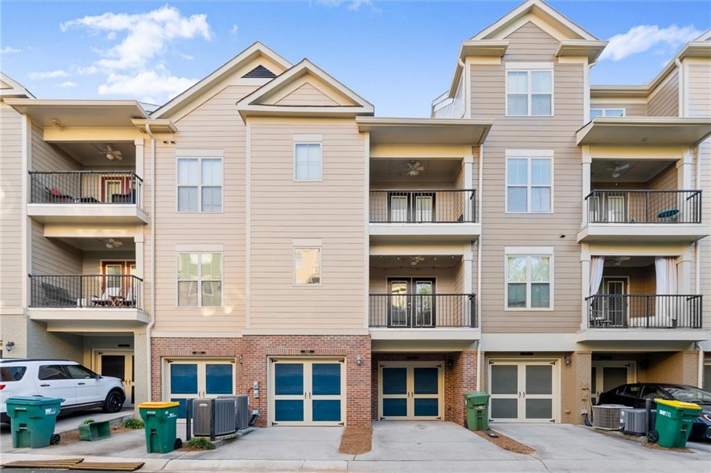6468 Chariot Street, Unit 19 Atlanta, GA 30328 - Photo 34 of 43 a front view of a residential apartment building with a yard