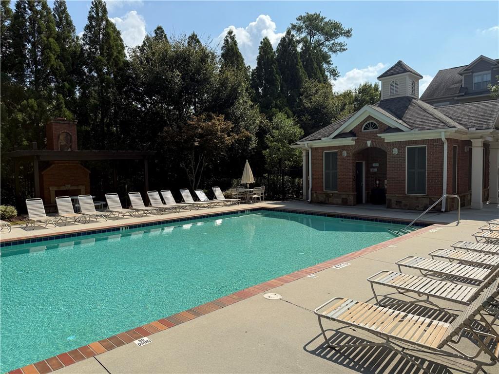 6468 Chariot Street, Unit 19 Atlanta, GA 30328 - Photo 37 of 43 a view of a house with pool and chairs