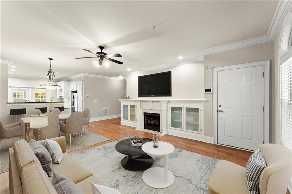 6468 Chariot Street, Unit 19 Atlanta, GA 30328 - Photo 5 of 43 a living room with furniture and a fireplace