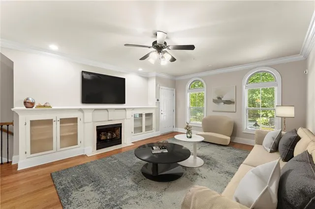 a living room with furniture a fireplace and a flat screen tv