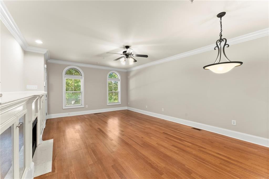 6468 Chariot Street, Unit 19 Atlanta, GA 30328 - Photo 9 of 43 a view of an empty room with a window and wooden floor