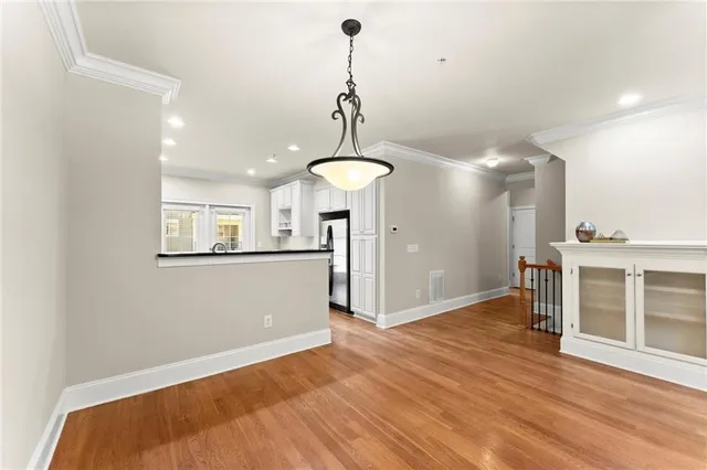 a view of a room with wooden floor
