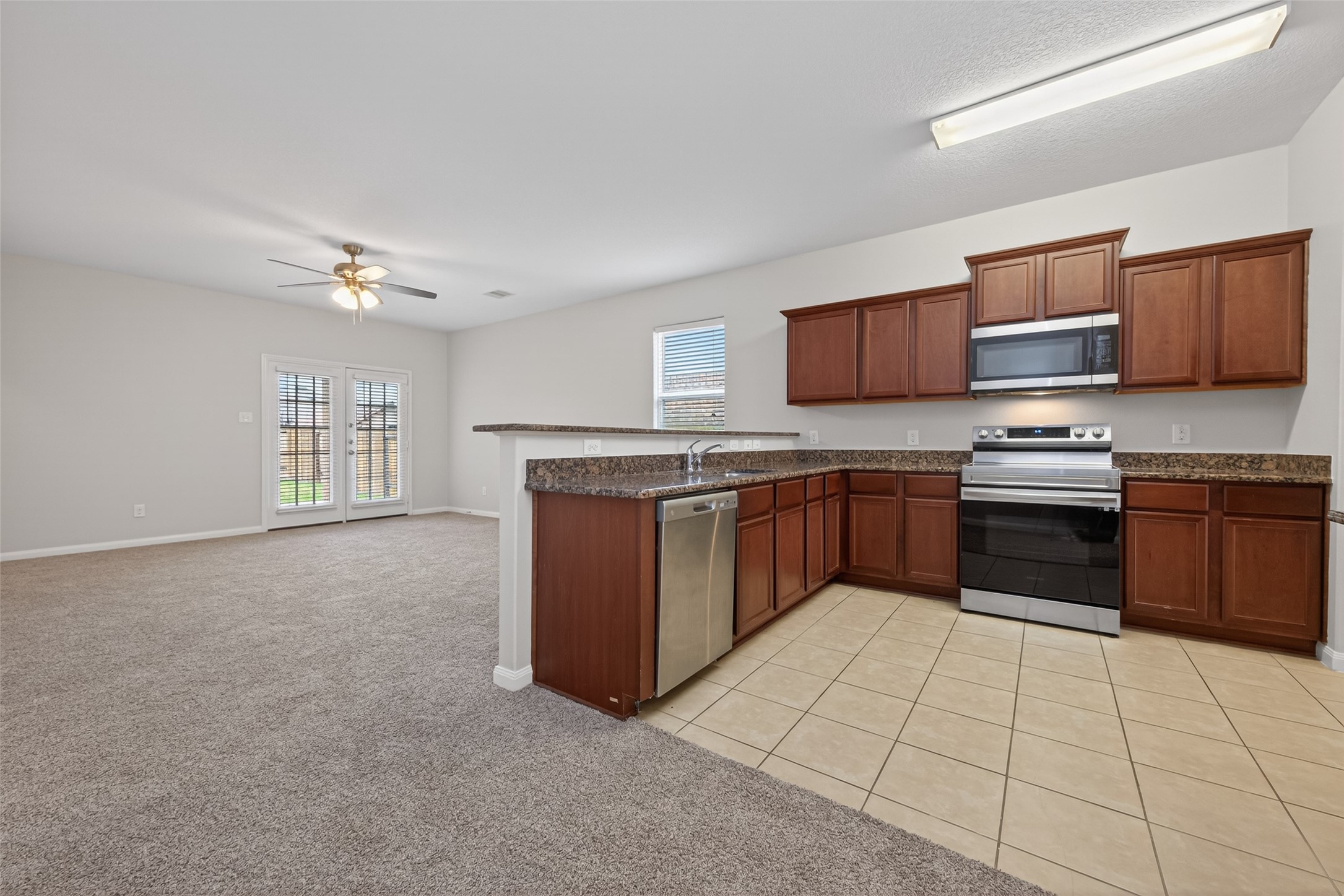 12038 Powderhorn Lane Pinehurst, TX 77362 - Photo 13 of 50 a kitchen with stainless steel appliances granite countertop a stove sink and cabinets