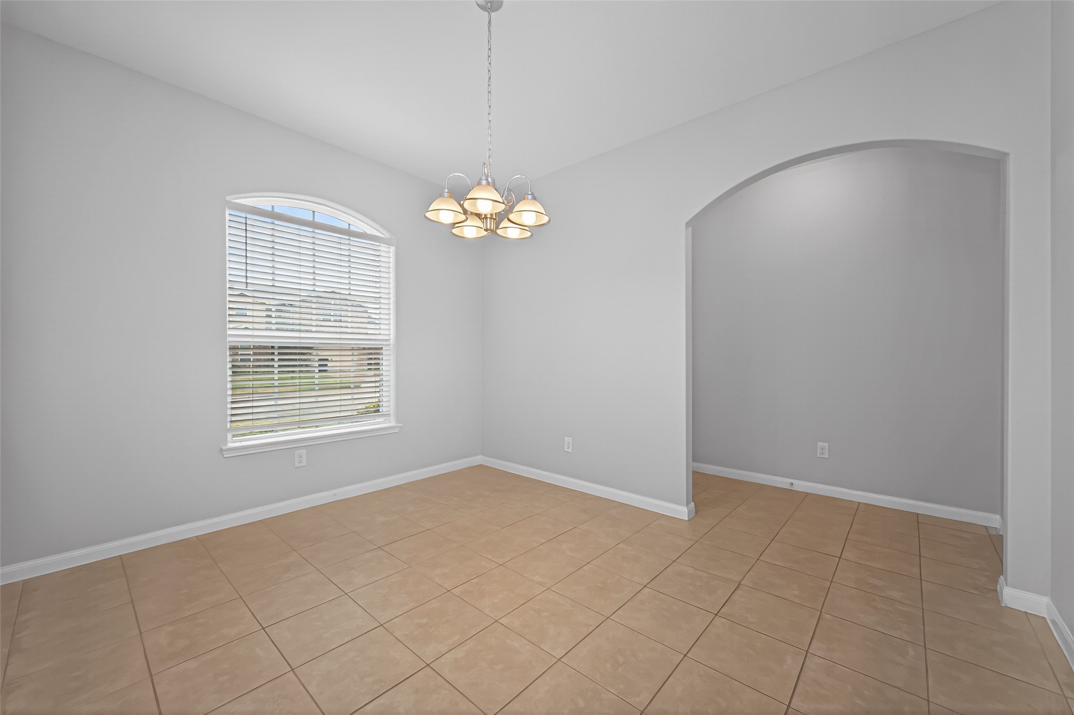 12038 Powderhorn Lane Pinehurst, TX 77362 - Photo 14 of 50 an empty room with chandelier fan and window