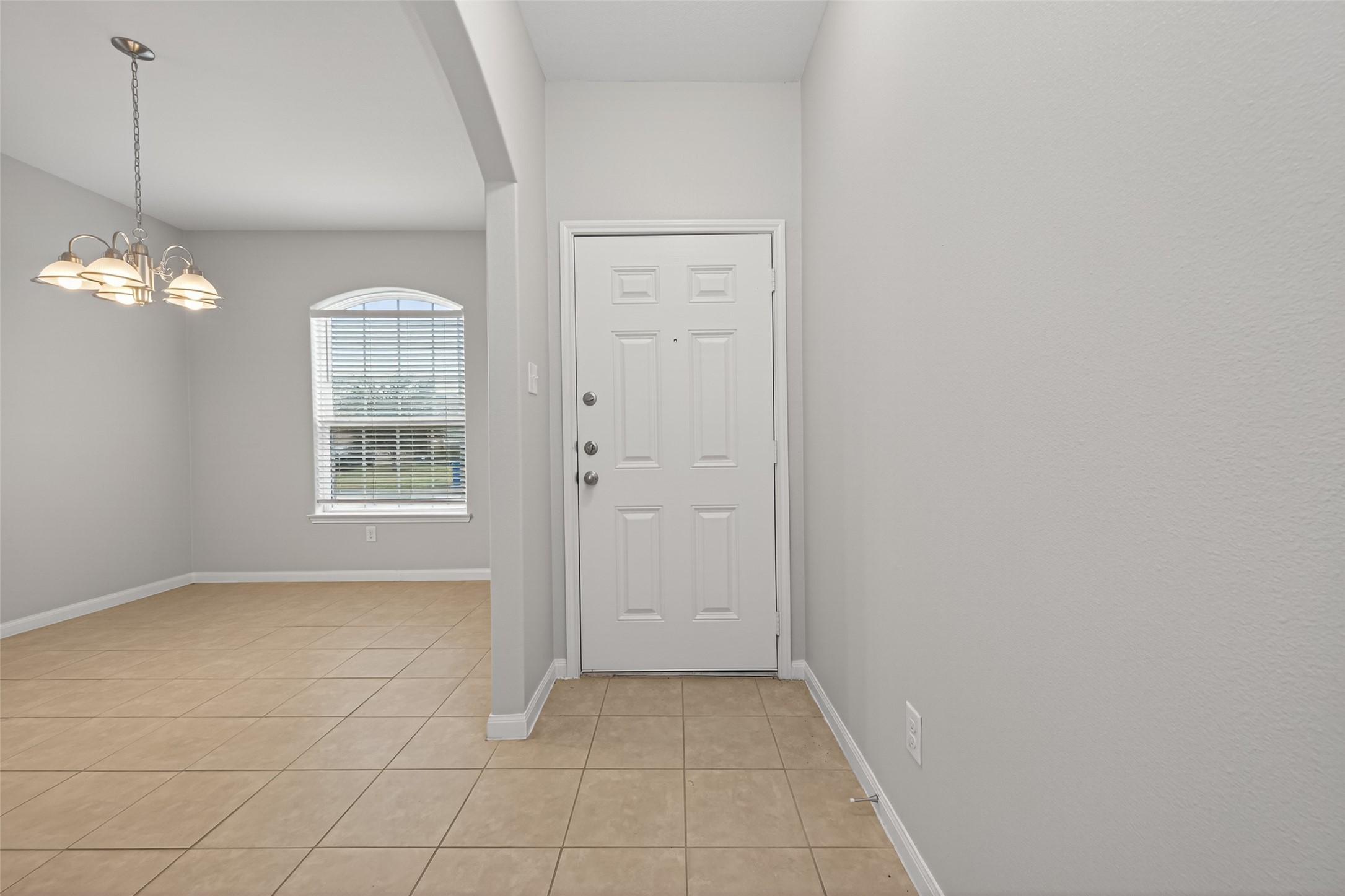 12038 Powderhorn Lane Pinehurst, TX 77362 - Photo 3 of 50 an empty room with windows and chandelier fan