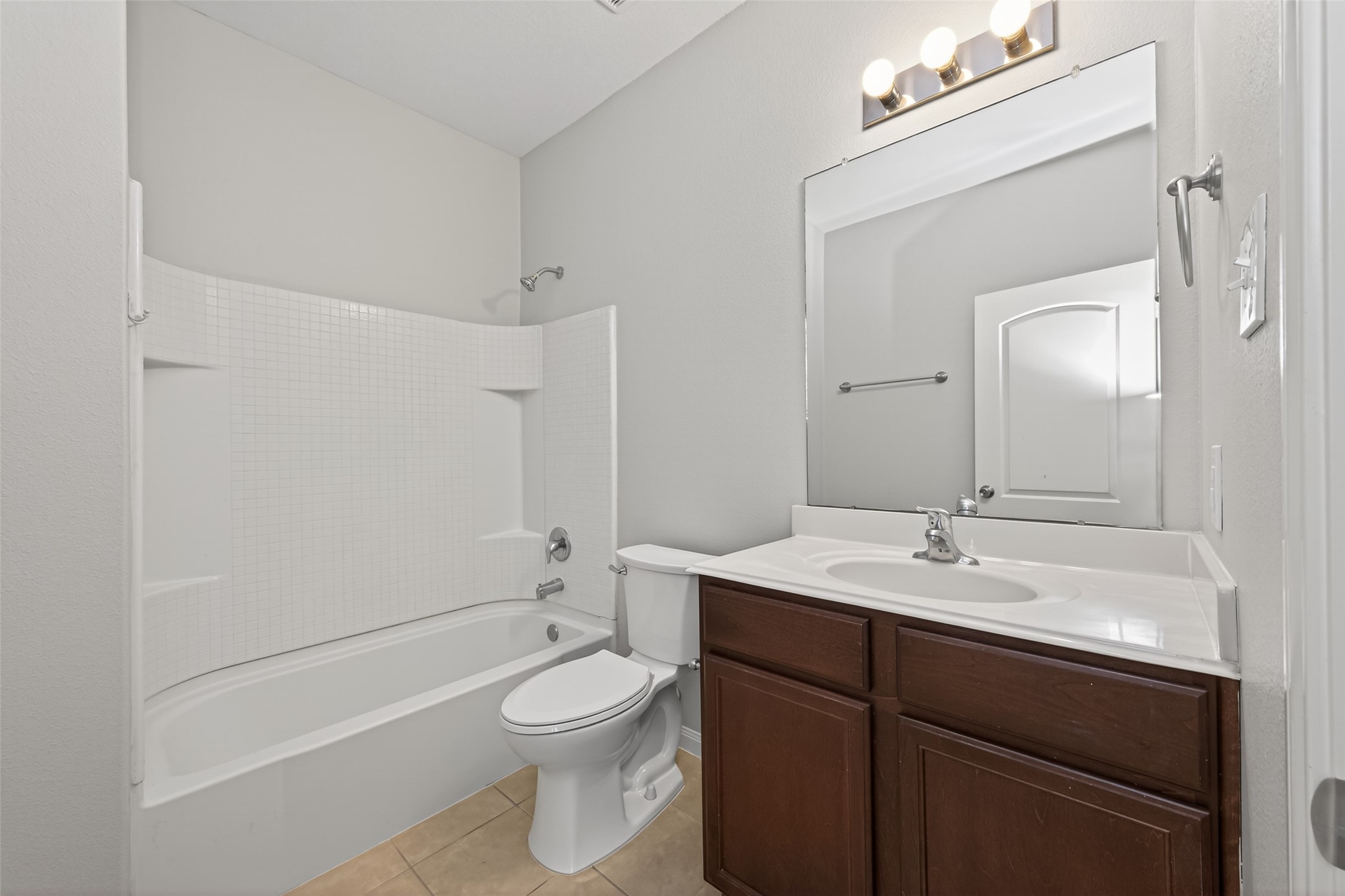 12038 Powderhorn Lane Pinehurst, TX 77362 - Photo 34 of 50 a bathroom with a toilet a sink a mirror and vanity