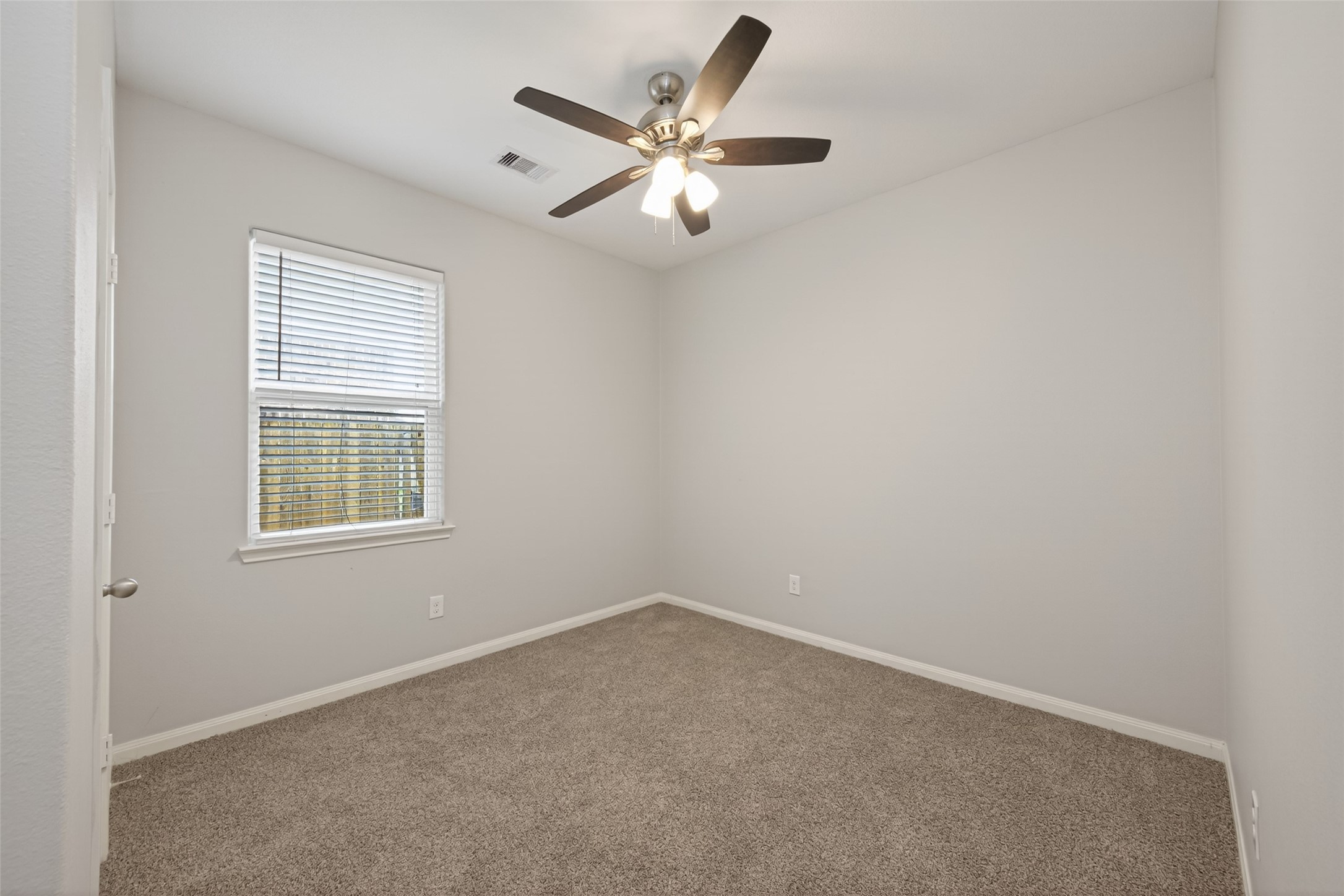 12038 Powderhorn Lane Pinehurst, TX 77362 - Photo 36 of 50 an empty room with ceiling fan and windows