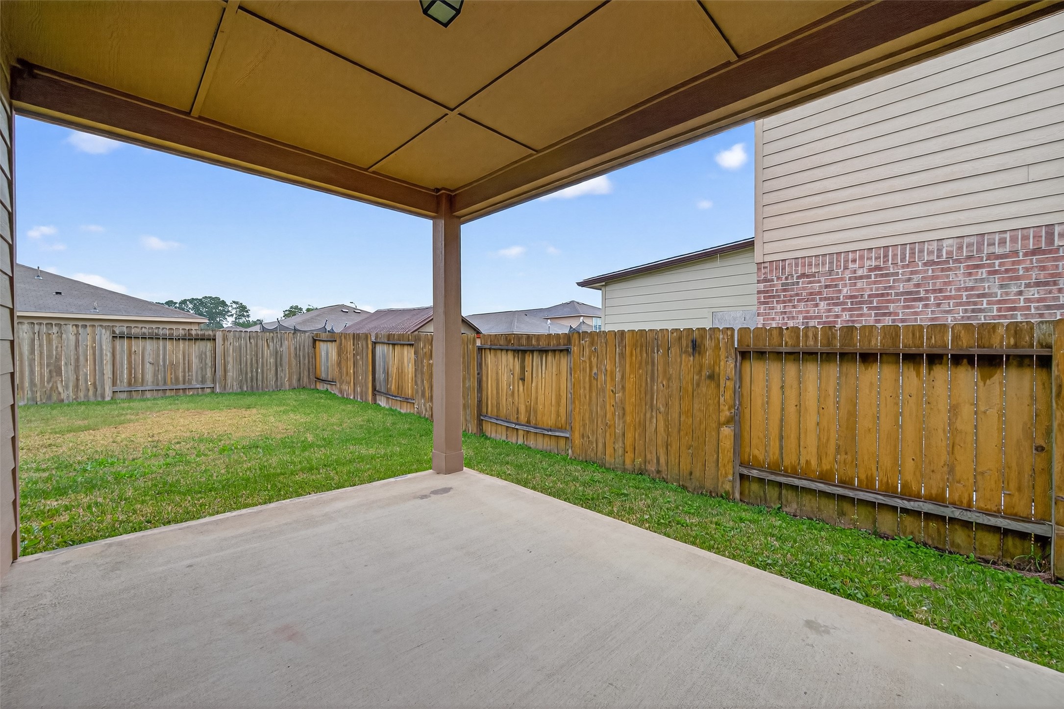 12038 Powderhorn Lane Pinehurst, TX 77362 - Photo 39 of 50 a view of a backyard with wooden fence